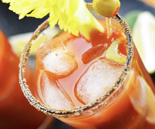 Spice up your sip with a bold Bloody Mary—zesty tomato juice, tangy lime, and a celery-olive garnish for the perfect kick!
