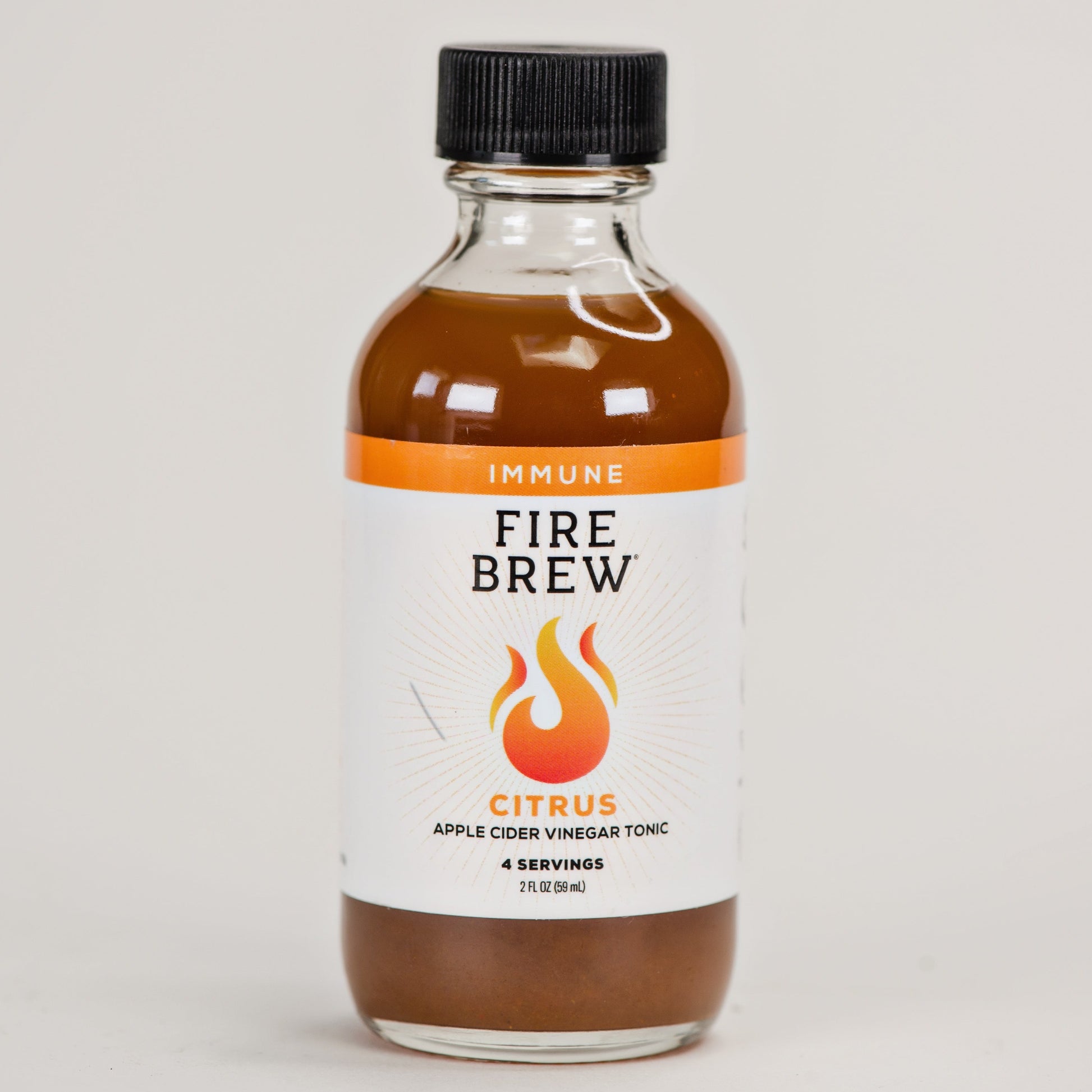 Front view of Fire Brew citrus apple cider vinegar tonic bottle with immune support label.