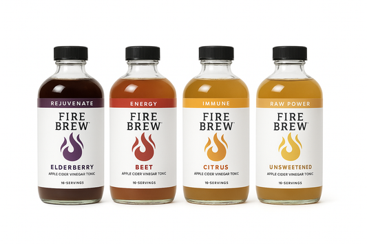 Four Fire Cider tonics bottles lined up on a white background showcasing Elderberry, Beet, Citrus, and Unsweetened varieties.
